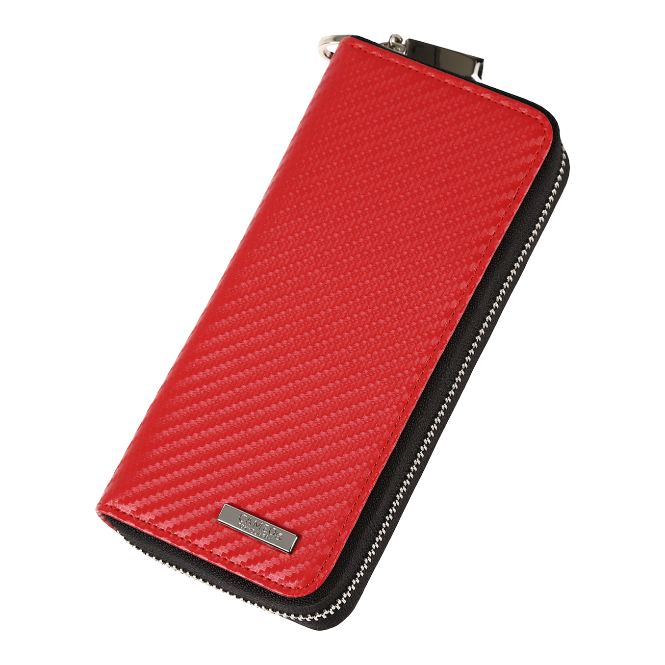 Cameo Business Case Pro3 Das Bild zeigt ein rotes Etui mit einer strukturierten Oberfläche und einem Reißverschluss. An der unteren Ecke befindet sich ein kleines Metallschild mit einer Gravur.